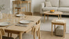 Nordic-leaning open-plan room showing dining, low, lift-top, and small desk tables in realistic scale with natural light and believable materials.