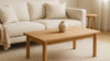 Bright Nordic living room with a neutral wool rug under a low coffee table, showing realistic scale, materials, and soft daylight.