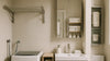 Compact bathroom and laundry corner with wall-mounted storage, a slim vanity, ventilated shelves, and moisture-friendly accessories arranged to keep the space calm and uncluttered.