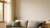 Warm, photorealistic living room editorial shot with a mid-budget designer-inspired sofa, showing tailored upholstery seams, realistic leg construction, and natural daylight scale.